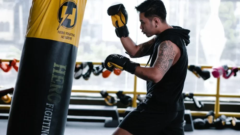 Image-of-a-man-practicing-right-uppercuts-on-a-sandbag